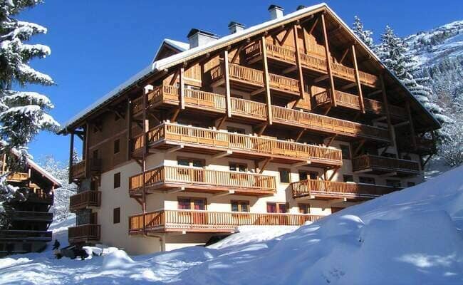 Ski-in chalet exterior with private balconies and mountain views
