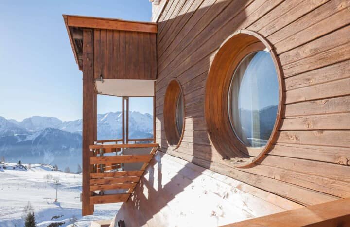 Chalet balcony and porthole windows with panoramic mountain views