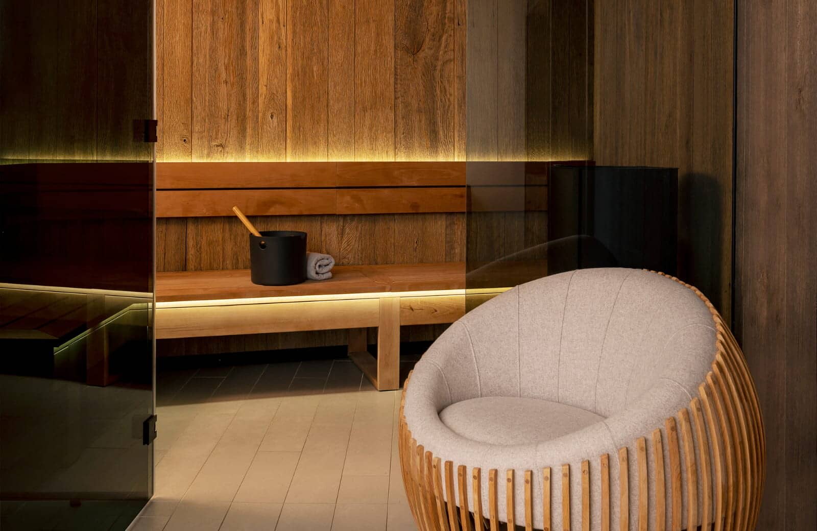 Private sauna with glass entry and integrated LED lighting