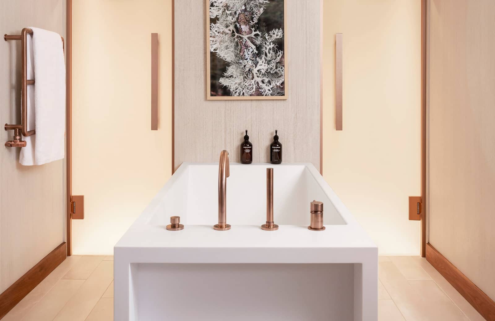 Soaking tub with rose gold hardware and heated towel rack