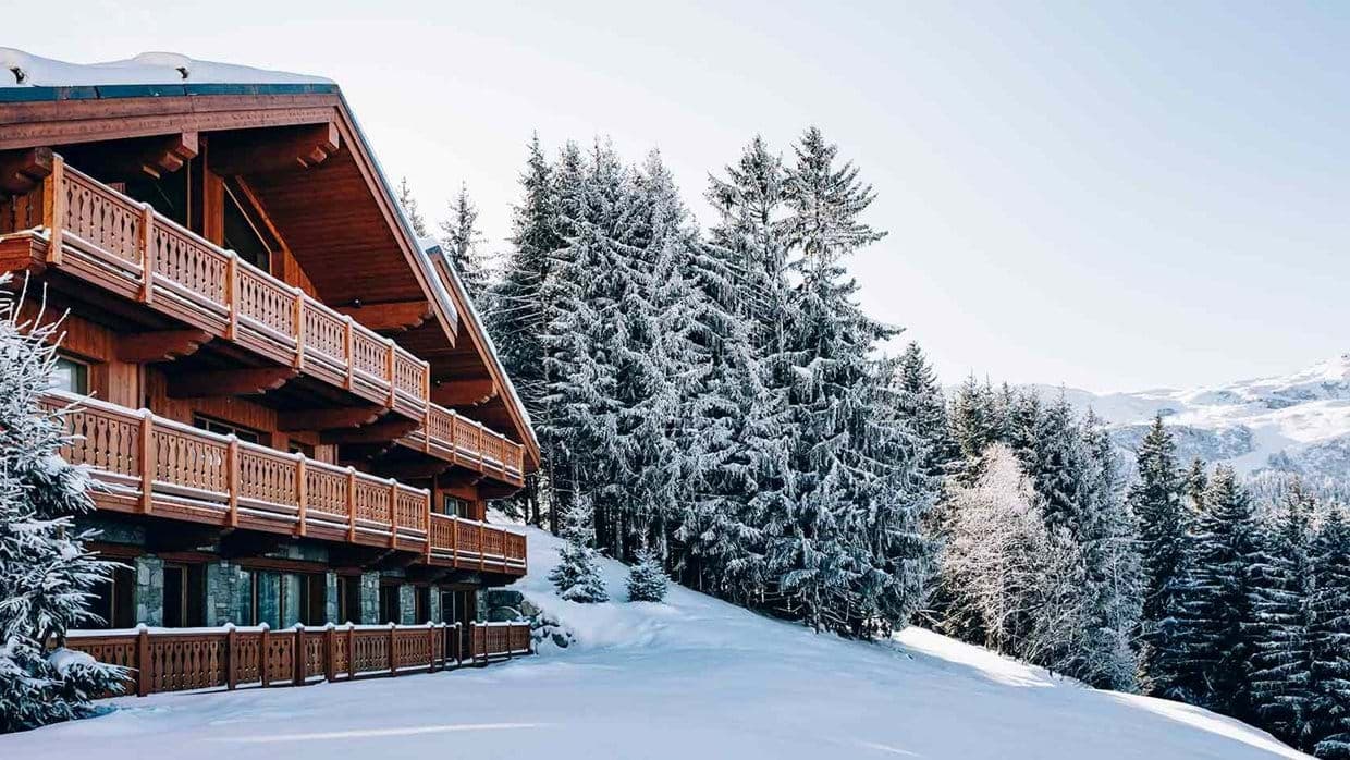 Multi-level timber chalet with tiered balconies and ski-in access