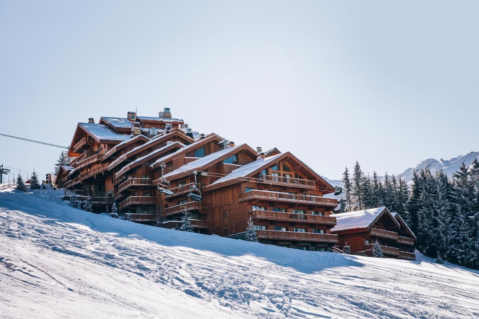Ski-in/ski-out chalet exterior with immediate access to groomed runs