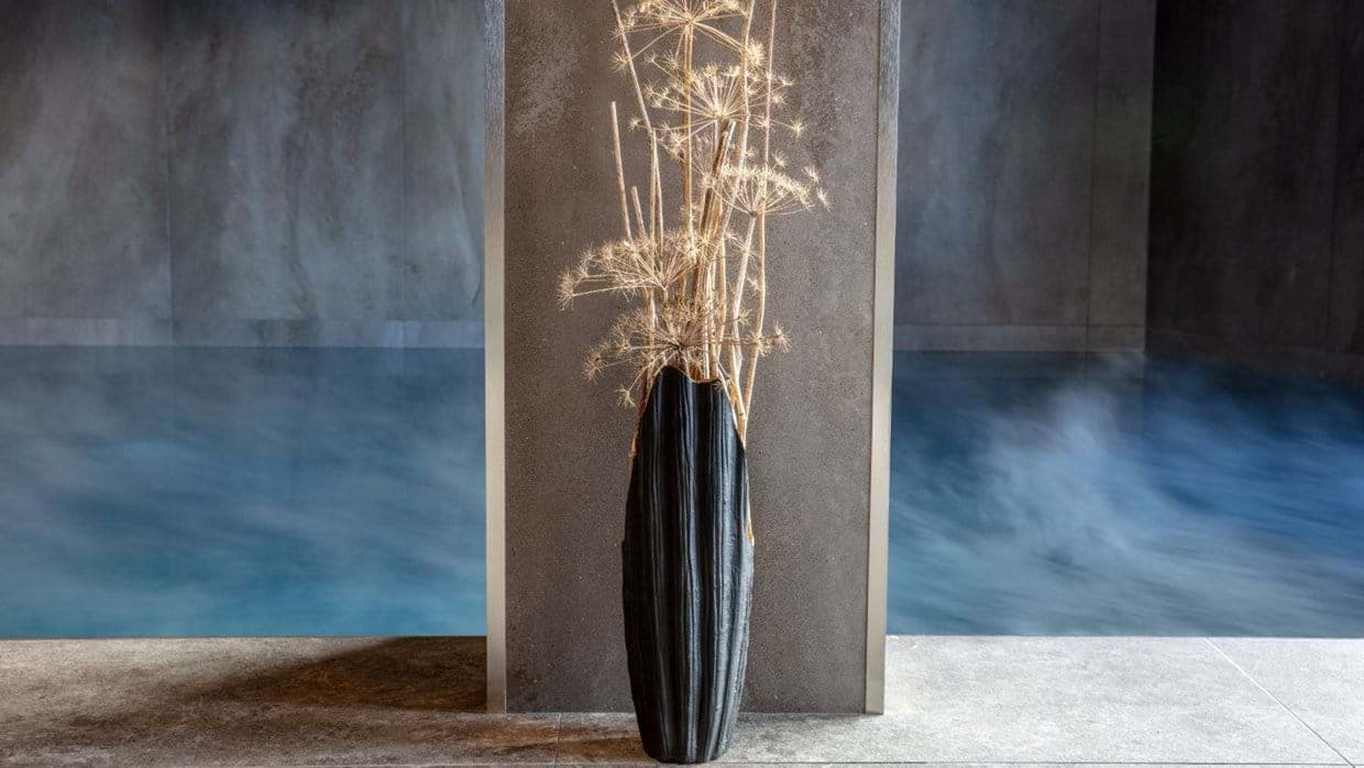 Heated indoor pool with steam and stone tile flooring