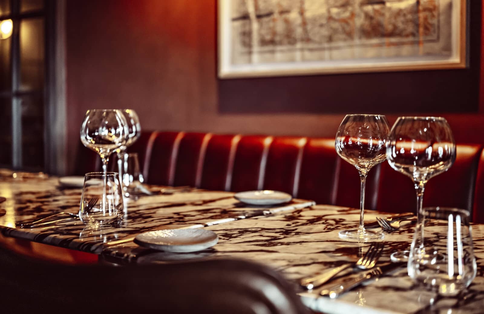 Dining area with marble table and leather banquette seating