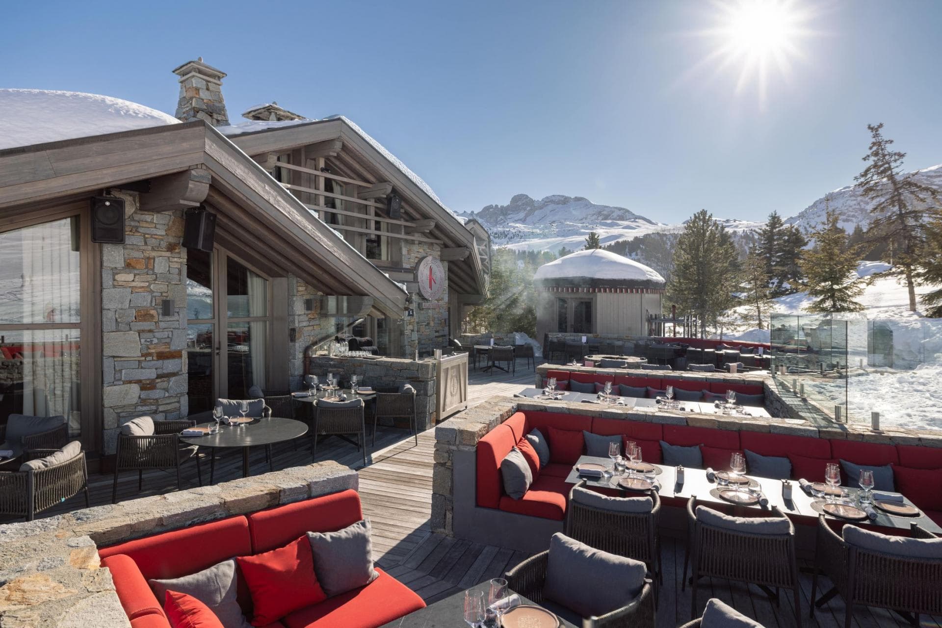 Ski-in/ski-out terrace with tiered lounge seating and mountain views