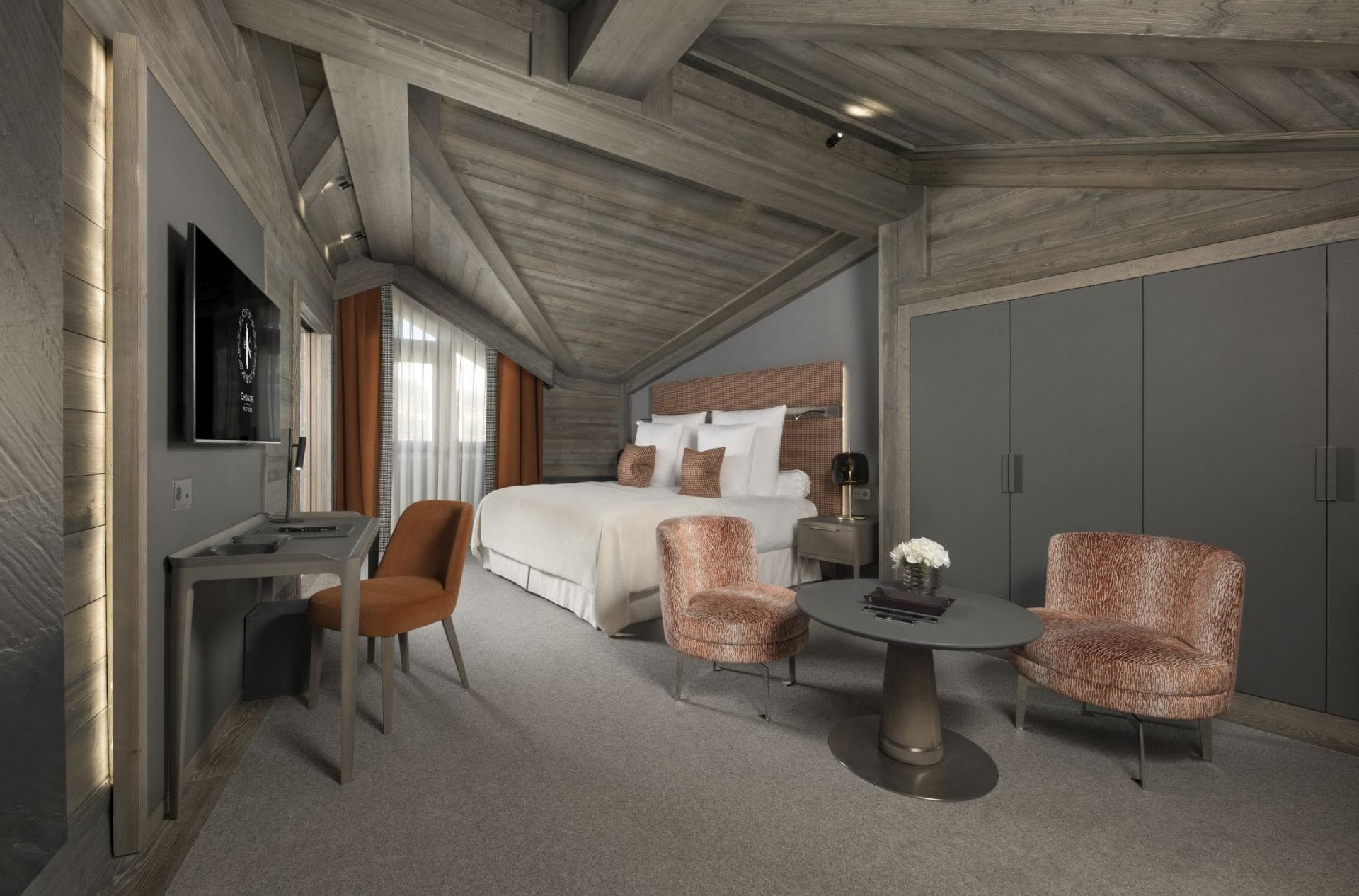 Primary bedroom with king bed, dedicated workspace, and built-in wardrobes