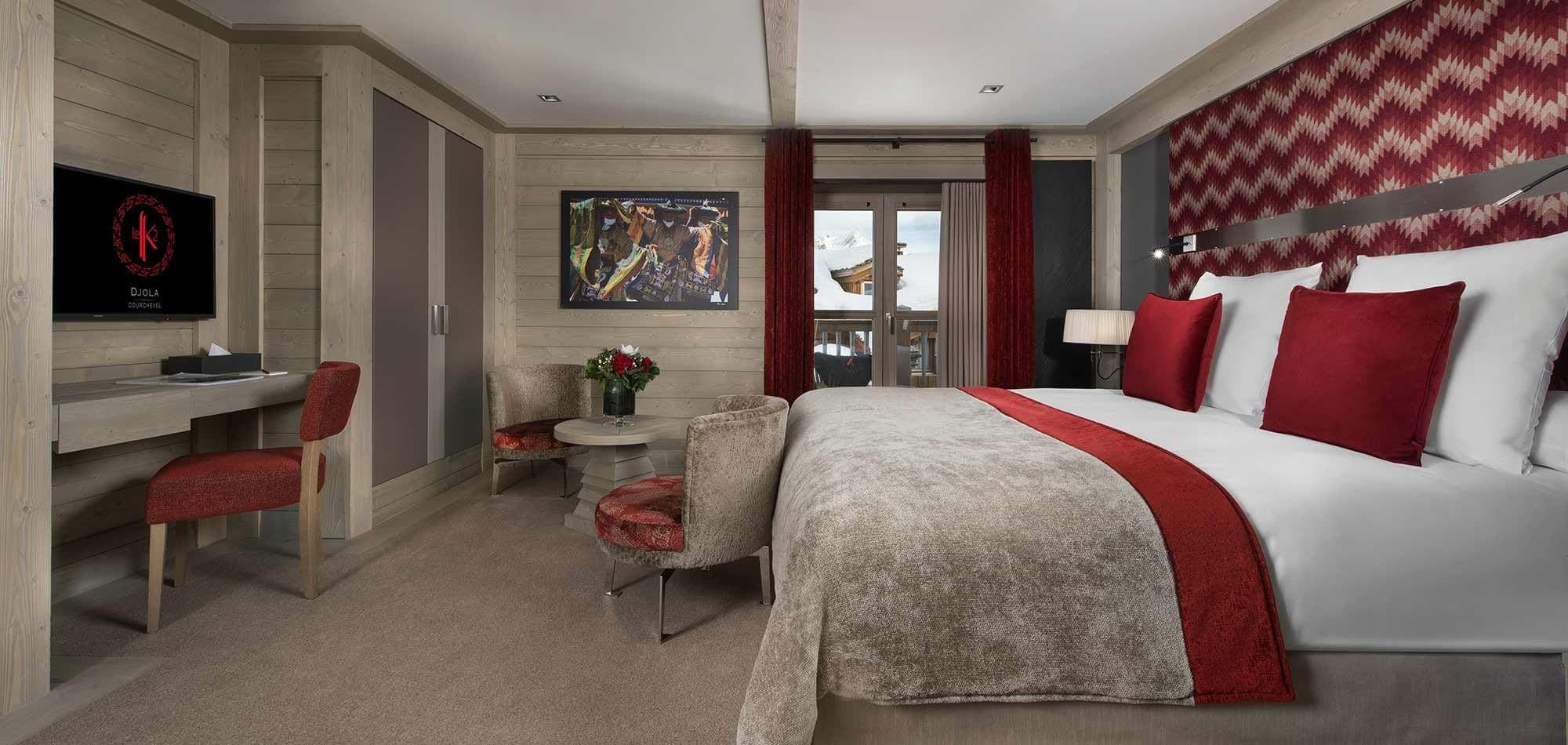 King bedroom with dedicated workspace and balcony access