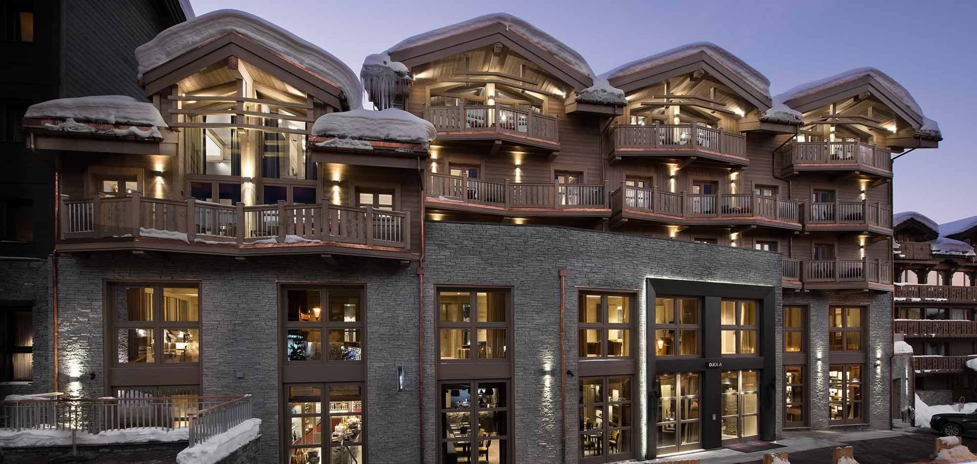 Chalet exterior with private balconies and ground-floor retail access