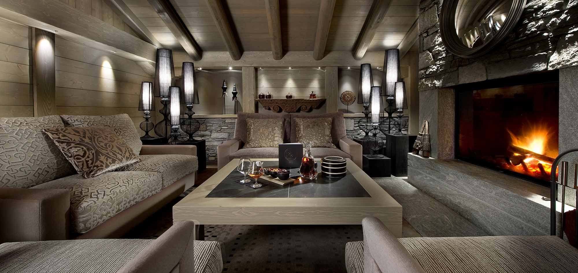 Lower level lounge with wood-burning fireplace and stone surround