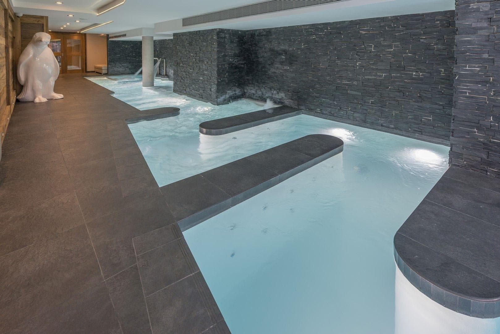 Indoor heated pool with hydrotherapy jets and waterfall feature