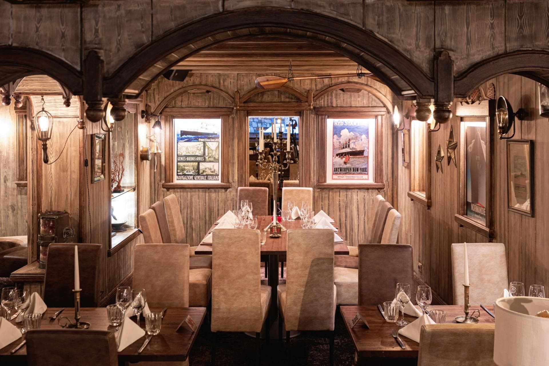 Nautical-themed dining room with wood paneling and seating for 10