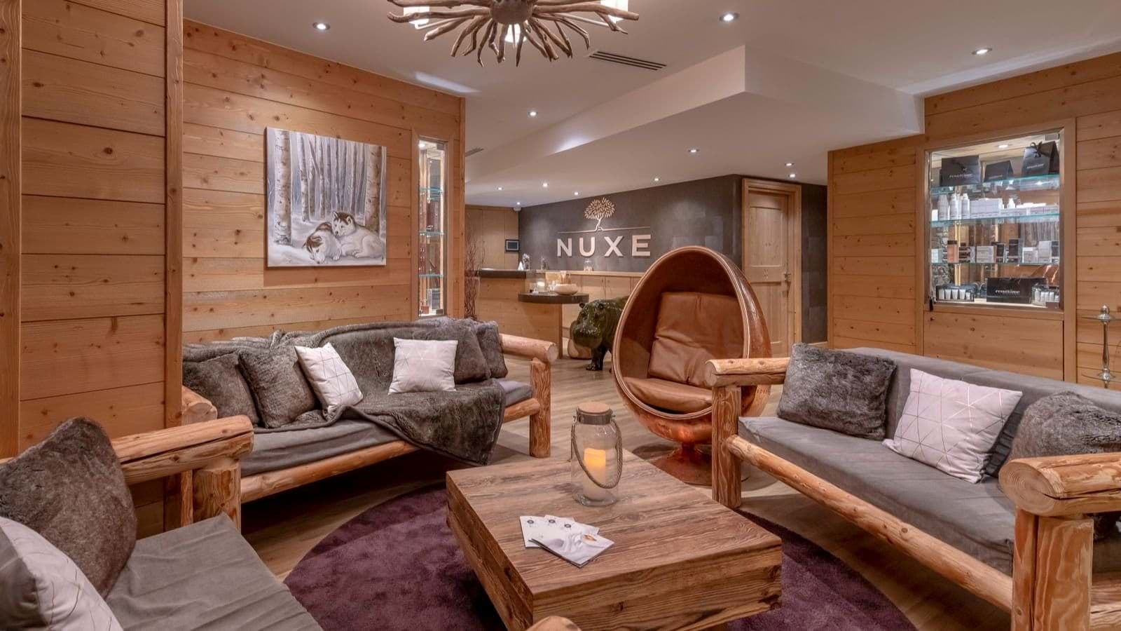 Spa reception lounge with NUXE products and seating for 10