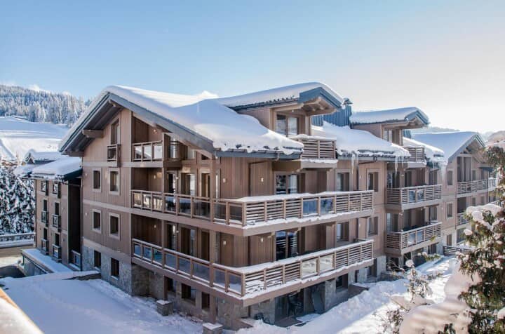 Ski-in apartment building with private balconies and mountain views