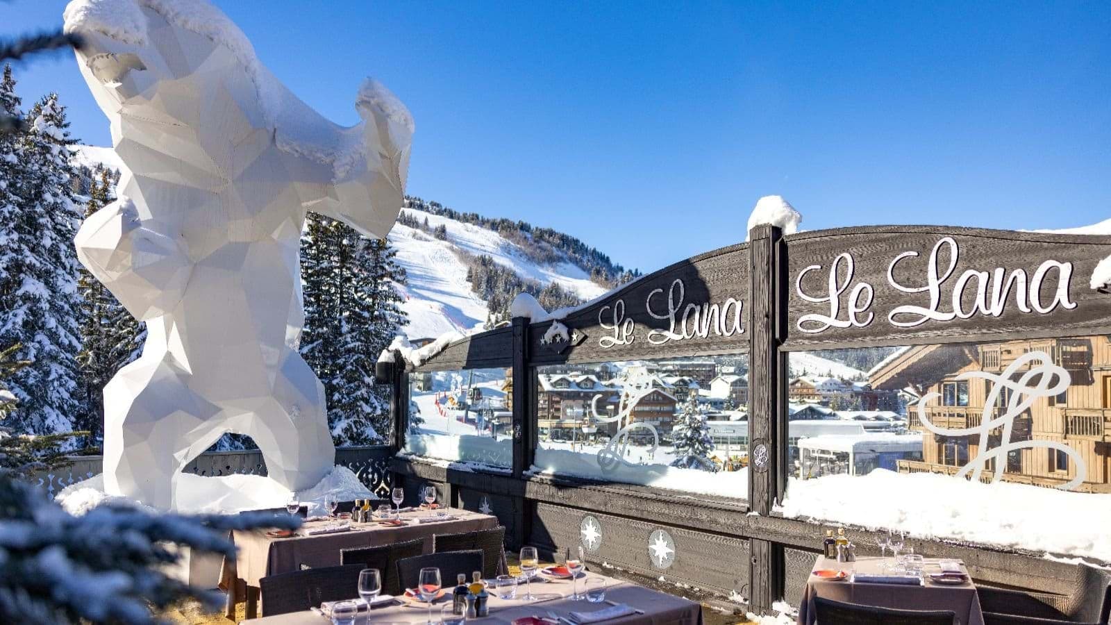 Outdoor terrace dining at Le Lana with mountain views and ski-in access