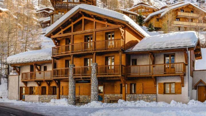 Multi-level alpine chalet with private balconies and stone-pillar entrance