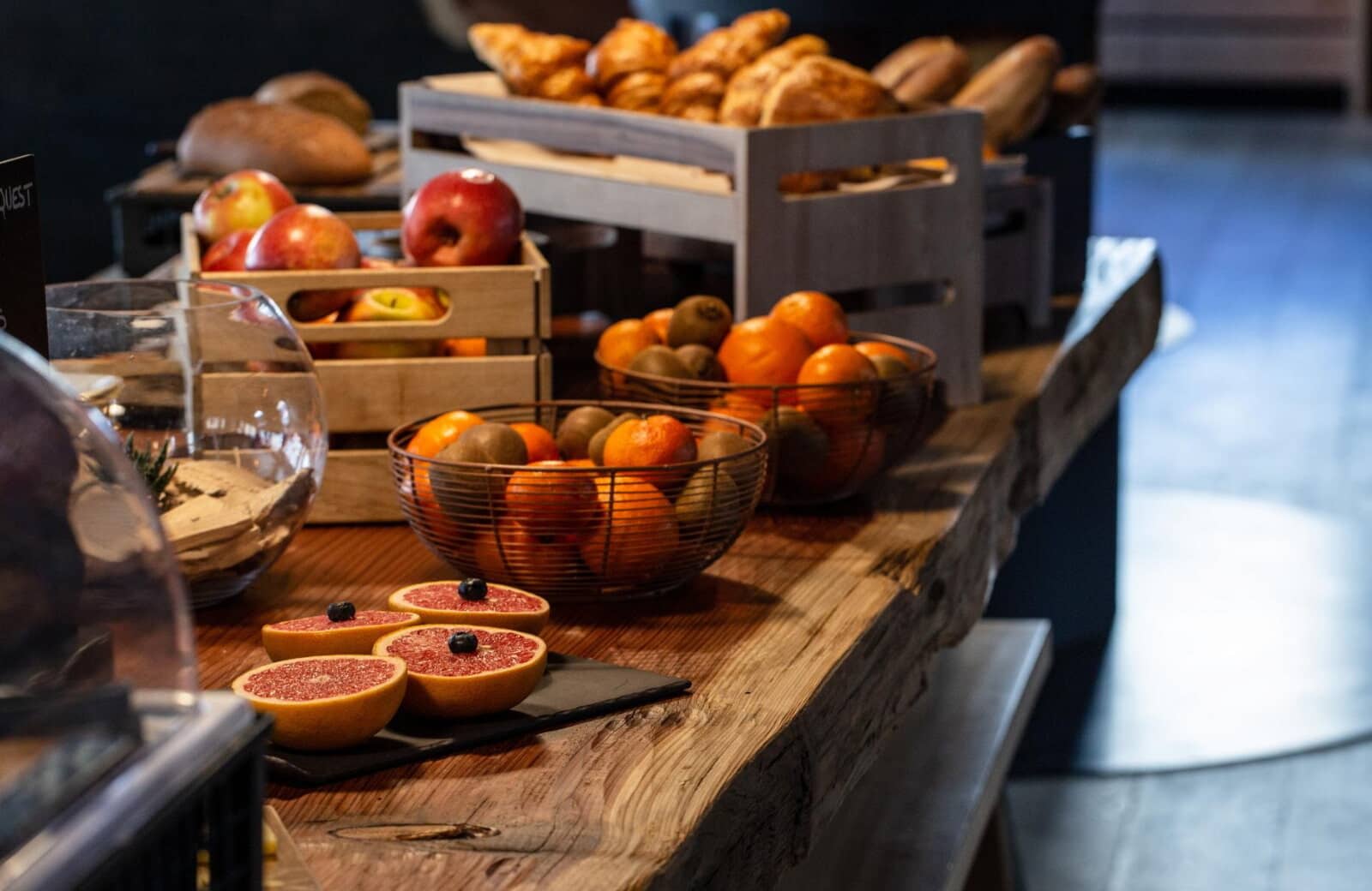 Breakfast station with fresh fruit, pastries, and artisanal bread selection