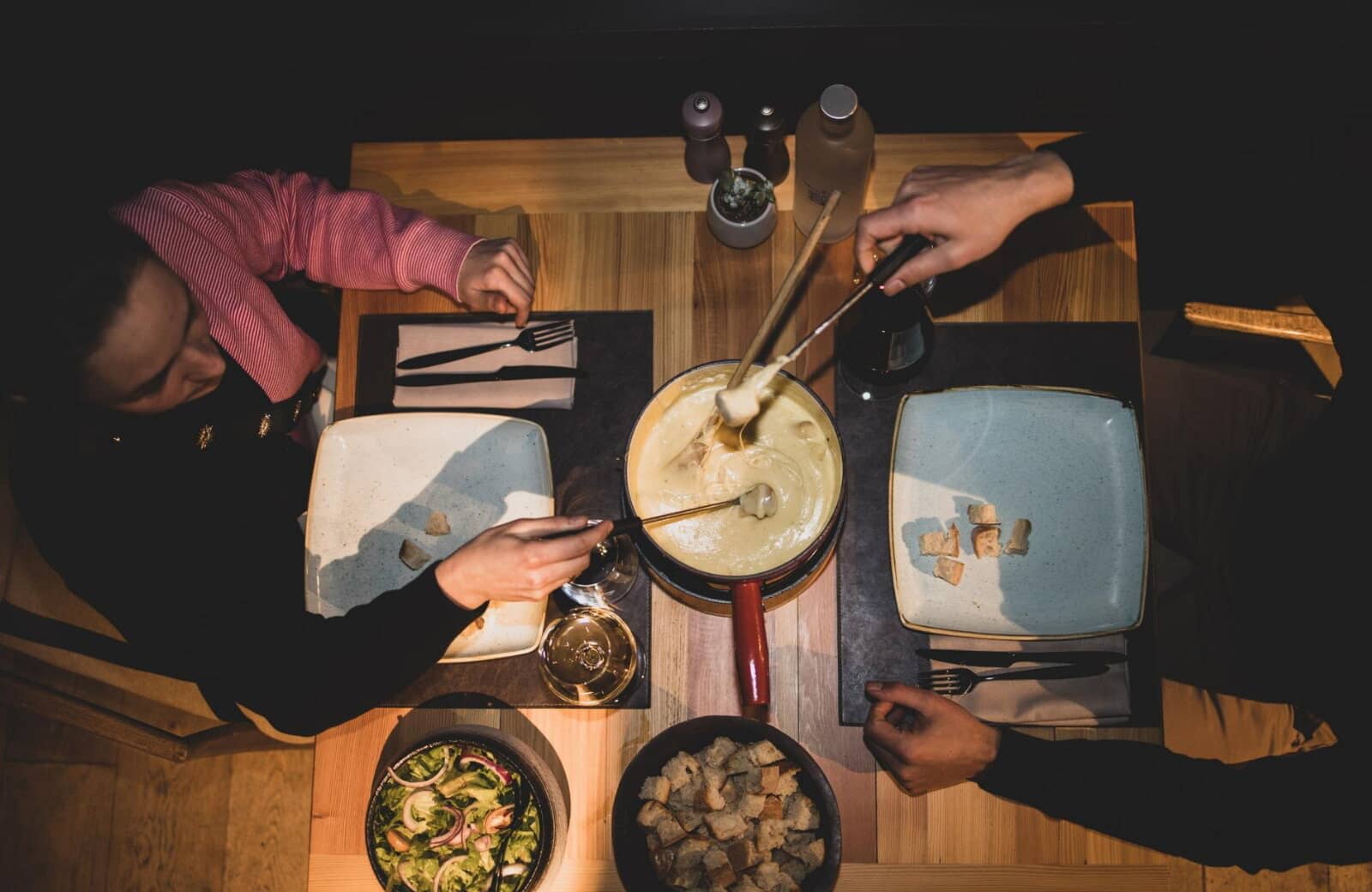 Dining table equipped with fondue set for shared alpine dinners