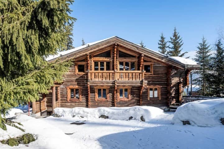 Log chalet exterior with private balcony and ski-in/ski-out access
