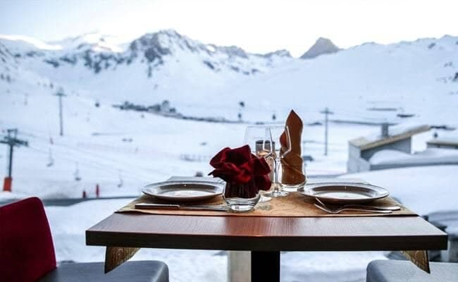 Dining area for two with views of the ski slopes and lifts