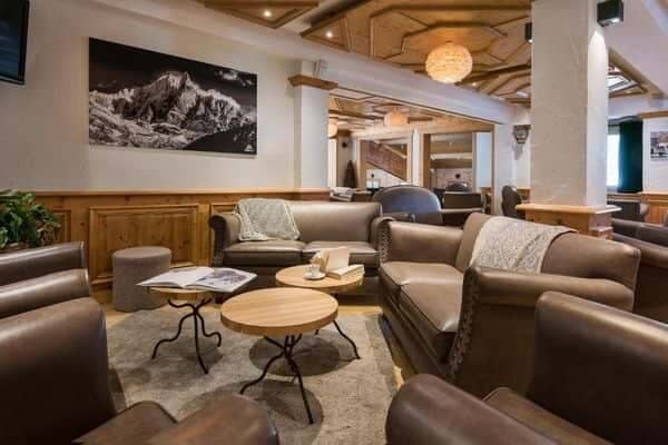 Shared lounge area with leather seating and coffered wood ceiling