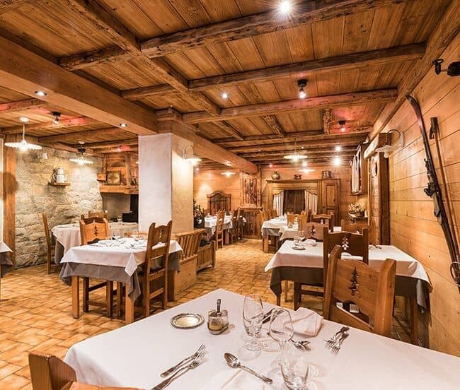Dining room with timber-beamed ceilings and seating for large groups