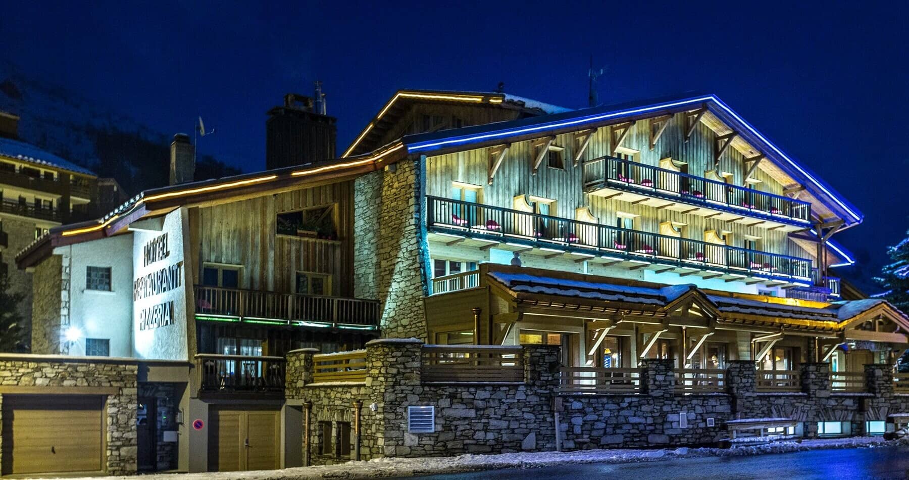 Chalet exterior with private balconies and on-site restaurant and pizzeria