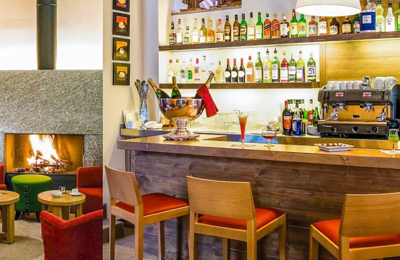 Home bar with professional espresso machine and fireplace seating