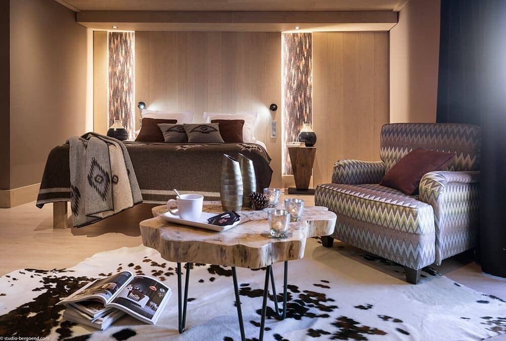 Primary bedroom with king bed and separate armchair seating area