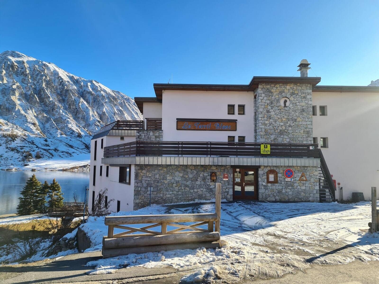 Chalet entrance featuring lakefront access and alpine mountain views