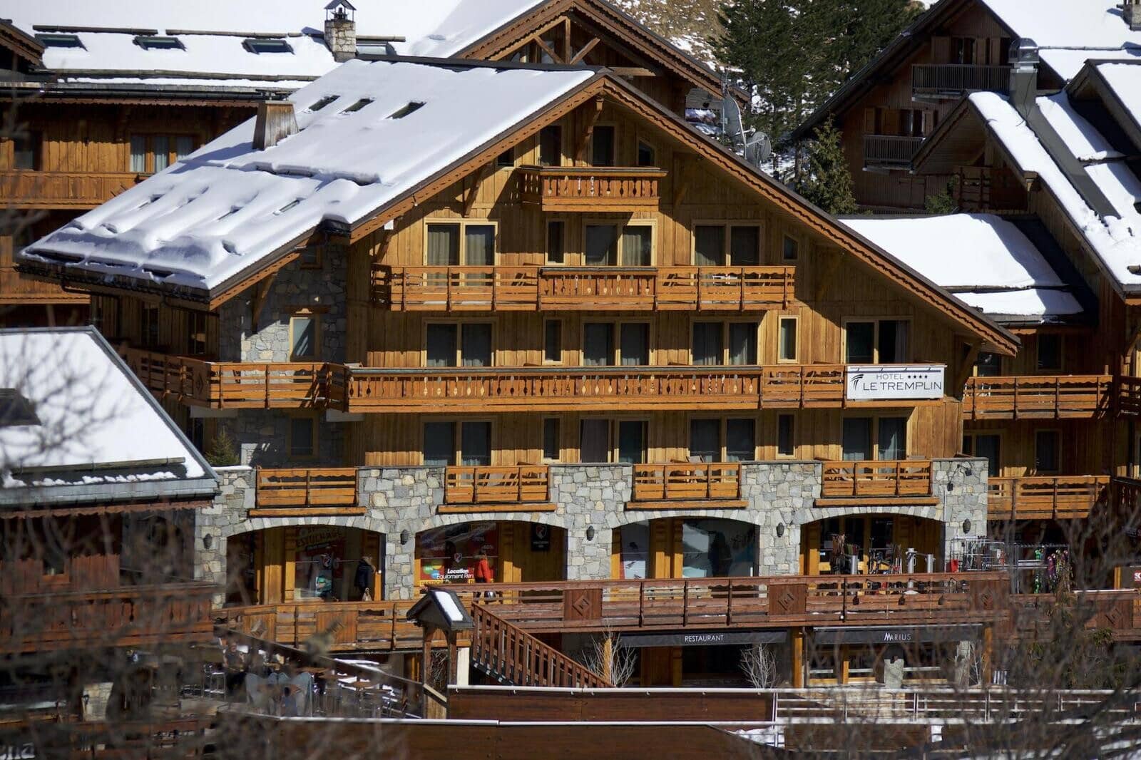 Chalet exterior with multiple private balconies and ground-level restaurant access
