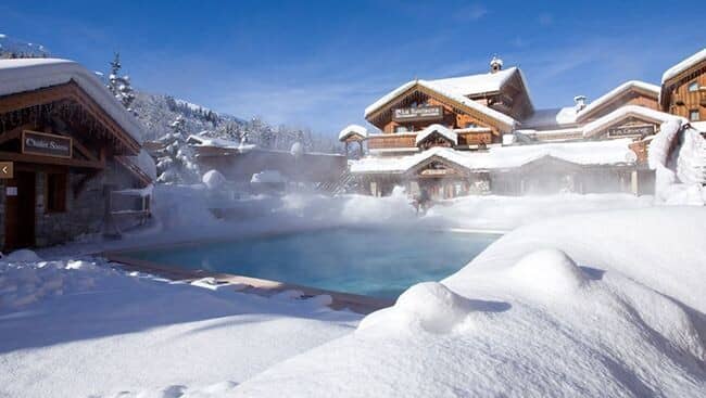 Heated outdoor pool and sauna building with mountain views