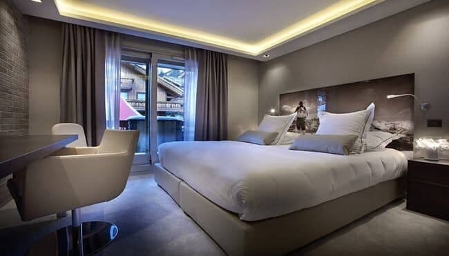 Bedroom with king bed, dedicated workspace, and private balcony access