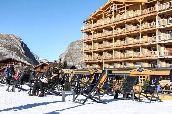 Ski-in/ski-out terrace with deck chair seating and mountain views