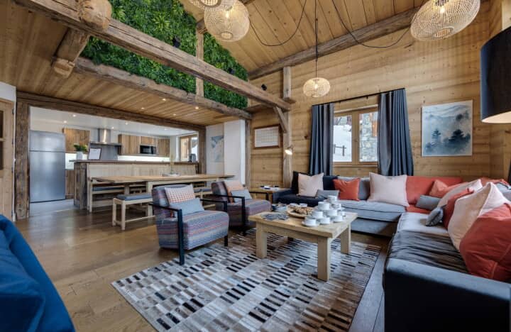 Open-plan living area and kitchen with vaulted ceilings and moss wall