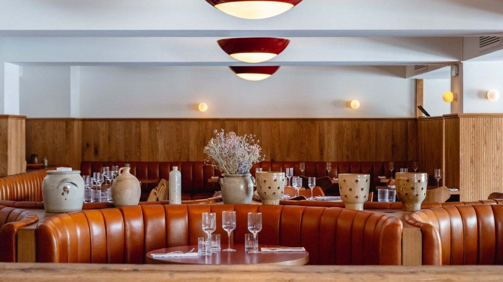 Dining area with leather booth seating and wood wainscoting