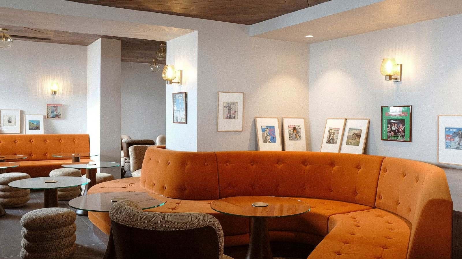 Lounge area with curved banquette seating and glass-top bistro tables