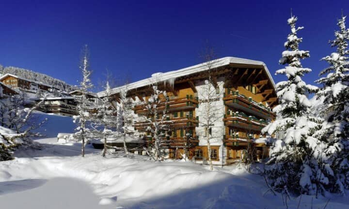 Ski-in chalet exterior with private balconies and mountain views