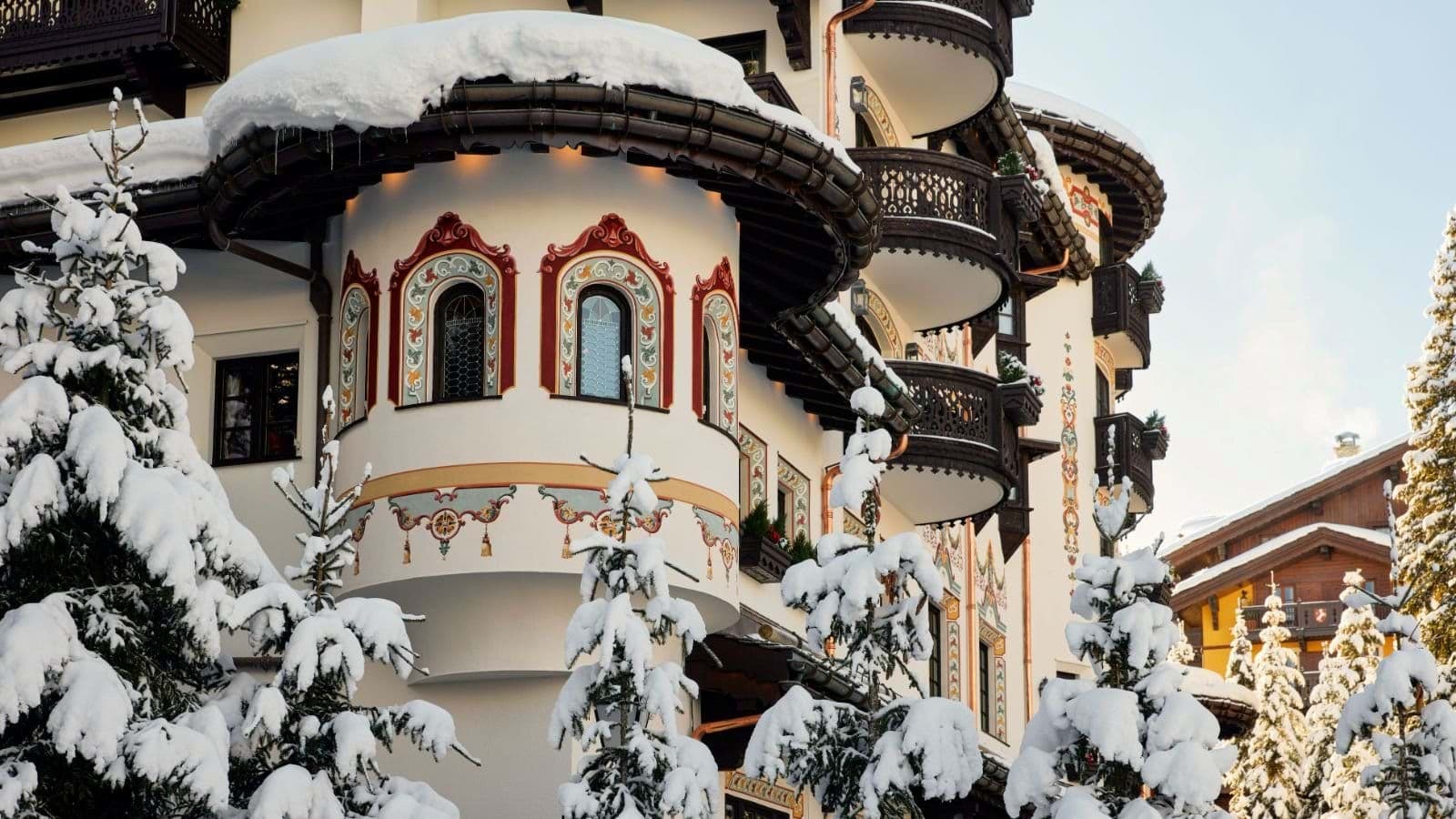 Alpine facade featuring hand-painted frescoes and private rounded balconies