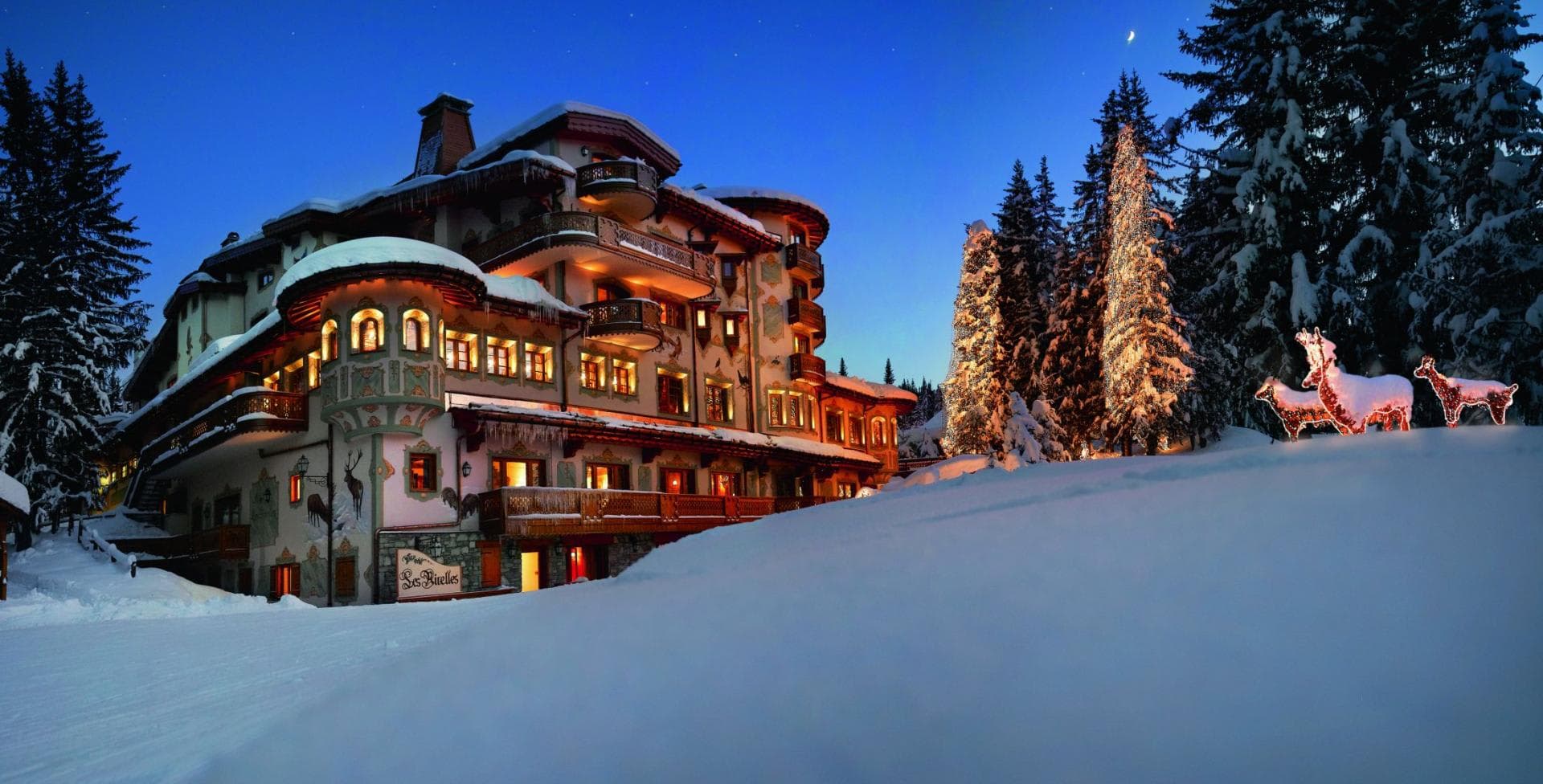Ski-in/ski-out chalet exterior with traditional hand-painted murals and private balconies