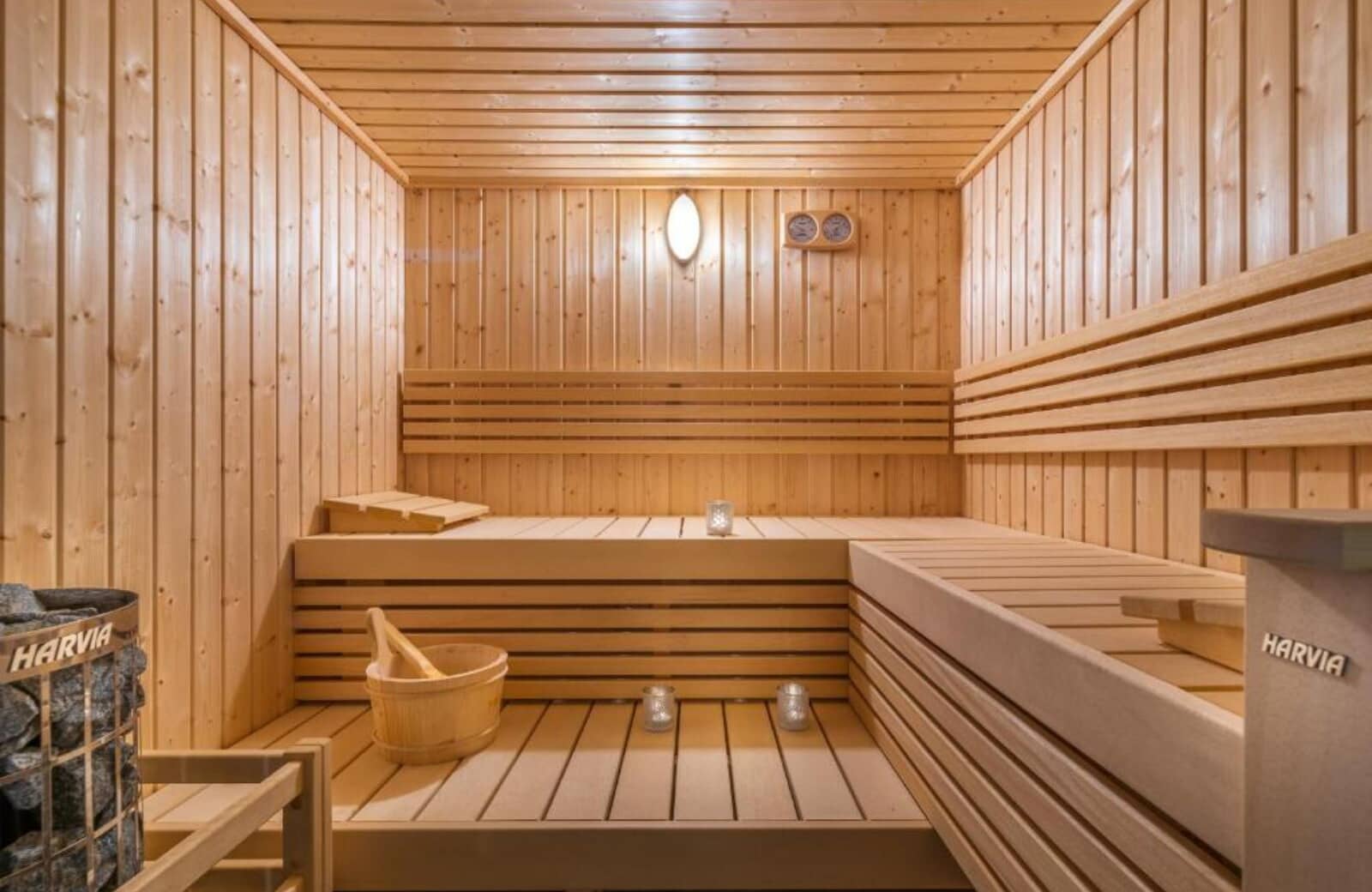 Private cedar sauna with Harvia electric heater and multi-level seating