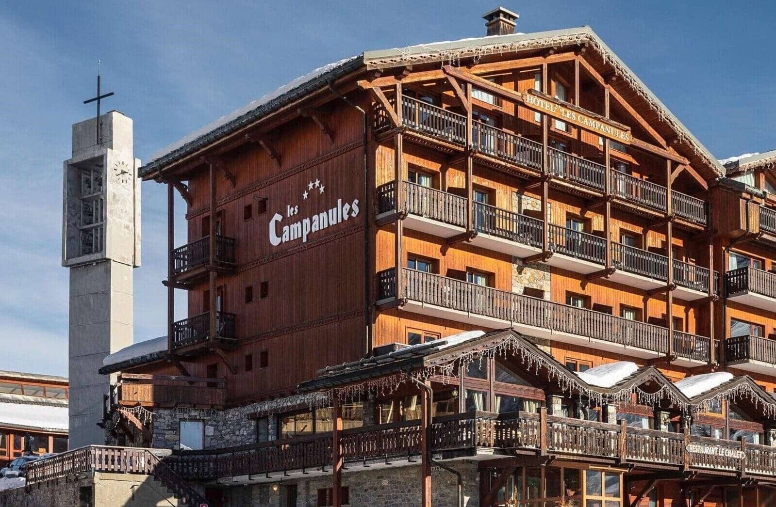 Chalet exterior featuring private balconies and proximity to the village clock tower