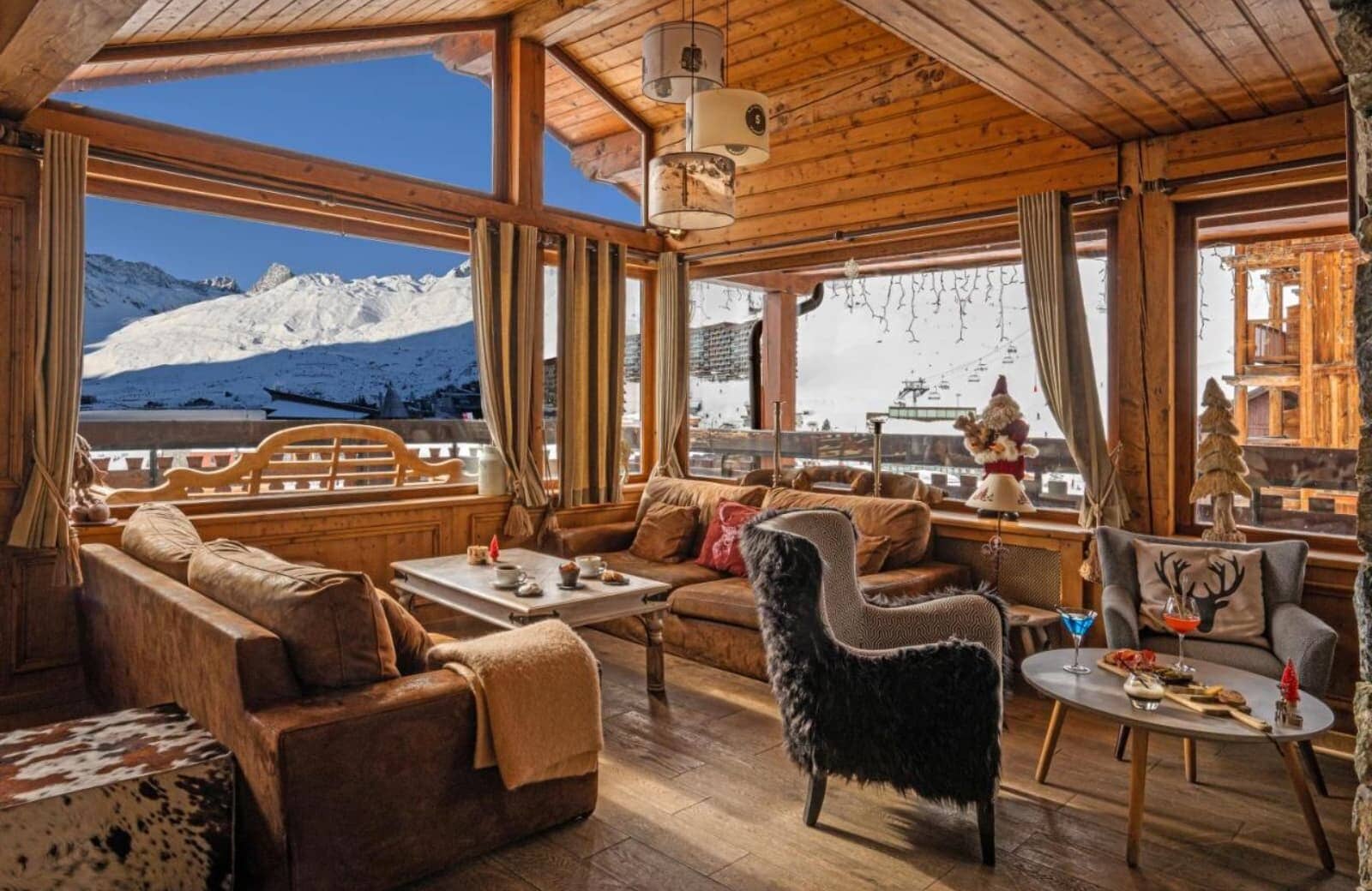 Living area with floor-to-ceiling windows and panoramic ski slope views
