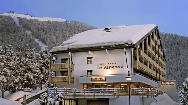 Hotel exterior featuring private balconies and onsite brasserie with ski slope access