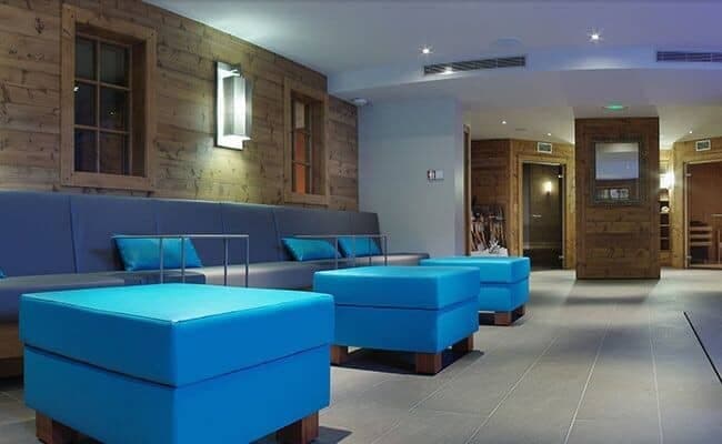 Spa lounge area with bench seating and adjacent sauna access