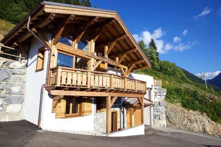 Chalet exterior featuring timber-framed balcony and proximity to ski lift