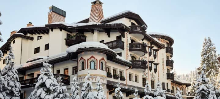 Alpine lodge featuring private balconies and hand-painted facade details
