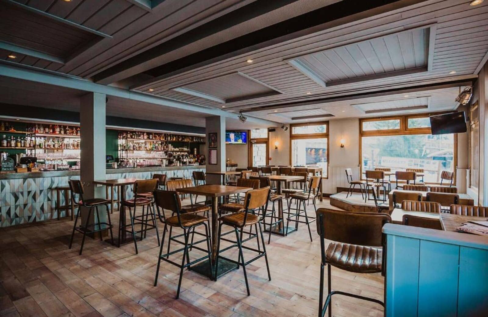 On-site bar and lounge area with high-top seating and flat-screen TVs