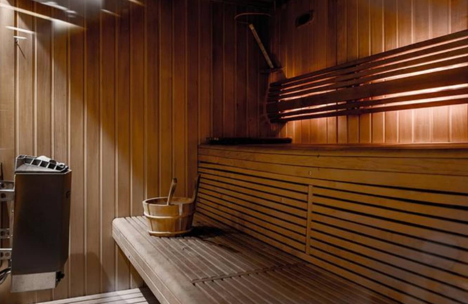 Private cedar sauna with tiered seating and electric heater