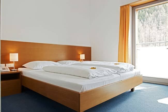 Guest bedroom with king bed and private balcony access