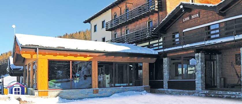 Ski-in/ski-out chalet exterior with sun terrace and private balconies
